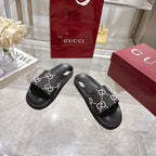 Gucci black slide sandals, GG logo print strap, contoured black rubber sole