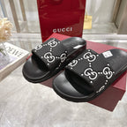 Gucci black slide sandals with GG logo strap detail and textured outsole