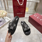 Gucci black slide sandal with GG logo strap and cushioned footbed