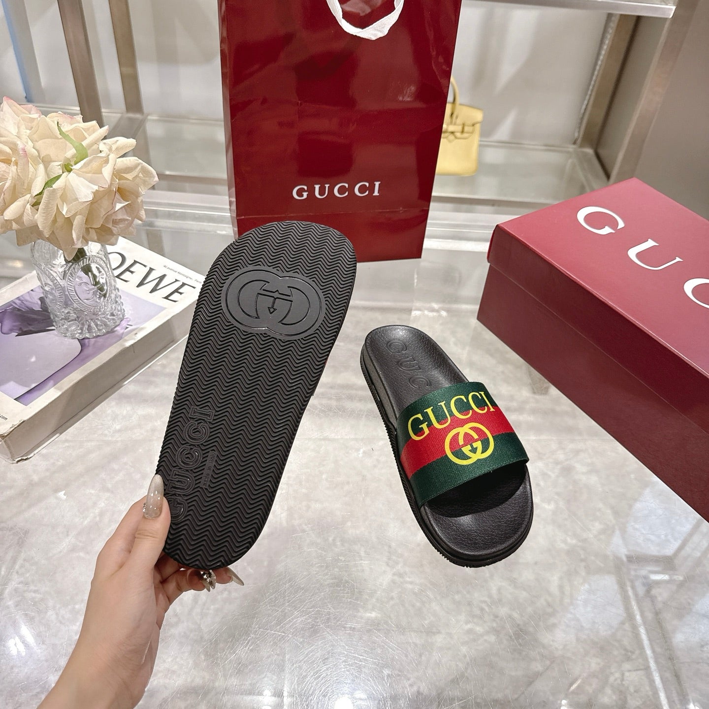 Gucci slide sandals bottom view with textured outsole and embossed GG logo