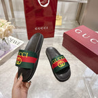 Gucci black slide sandals with green-red-green GG strap detail