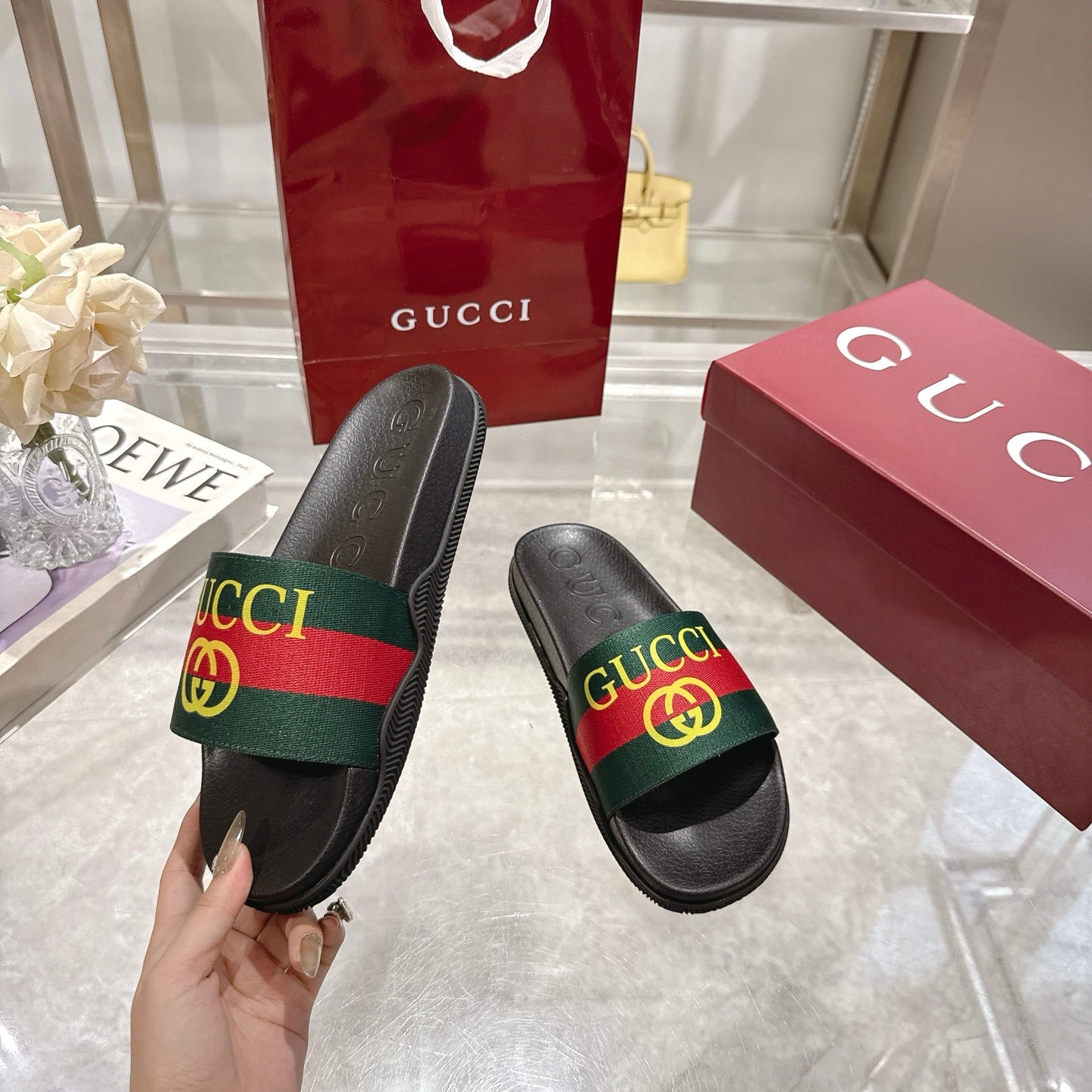 Gucci black slide sandals with green-red-green GG strap detail