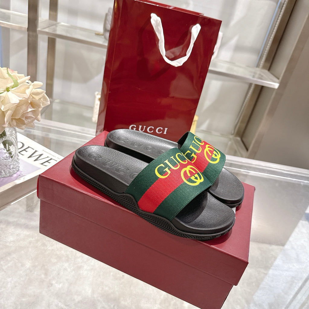 Gucci slide sandals with black straps and green-red-green GG web logo band