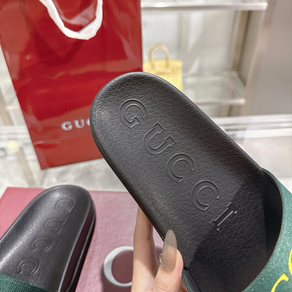 Gucci black slide sandal footbed with embossed GG logo and textured tread