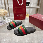 Gucci black slide sandals with cushioned footbed and GG web stripe strap