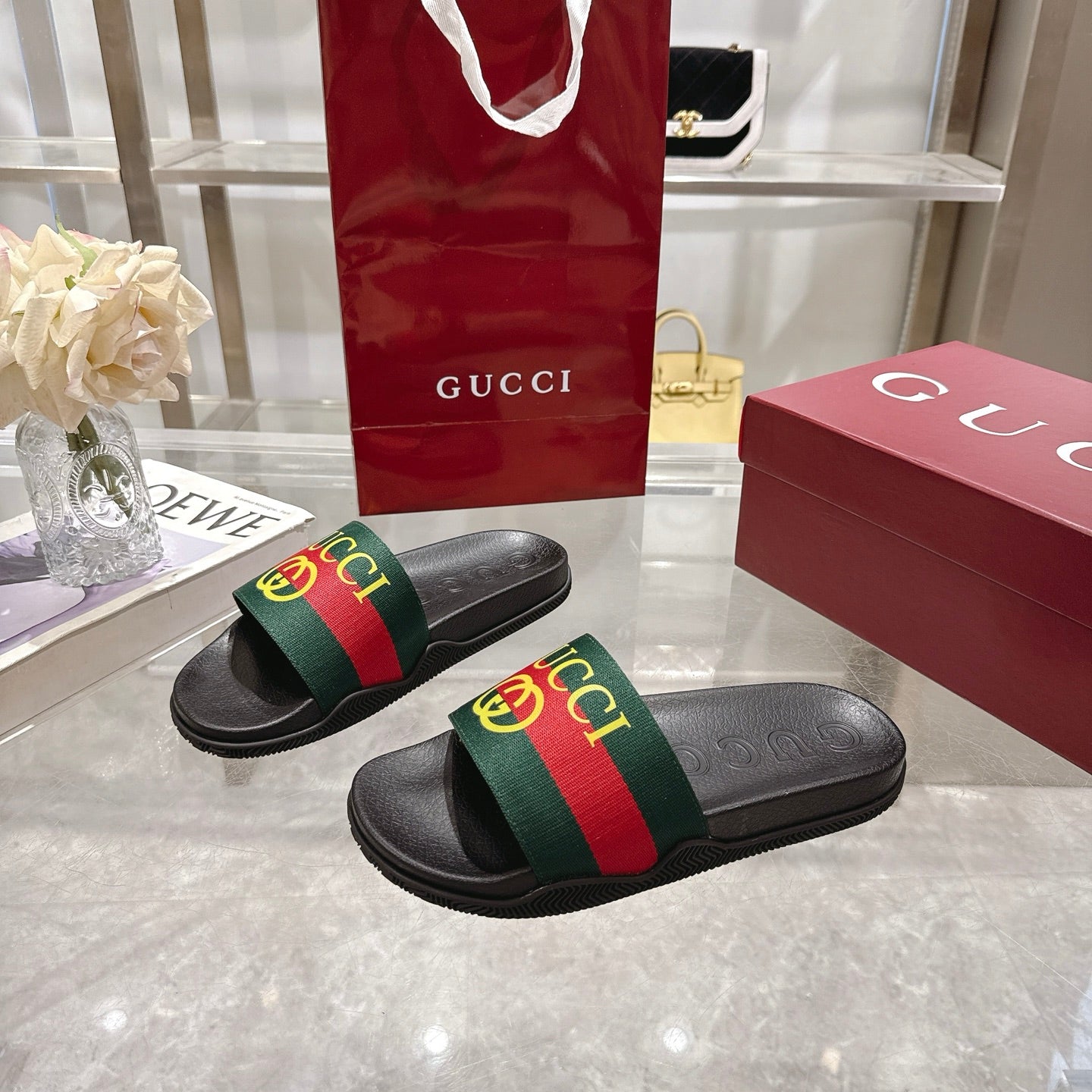 Gucci black slide sandals with cushioned footbed and GG web stripe strap