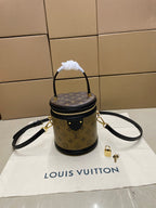 Louis Vuitton mini bucket bag in monogram canvas with black trim and top handle