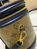 Louis Vuitton bag close-up of gold key charm and black zipper edge on monogram canvas