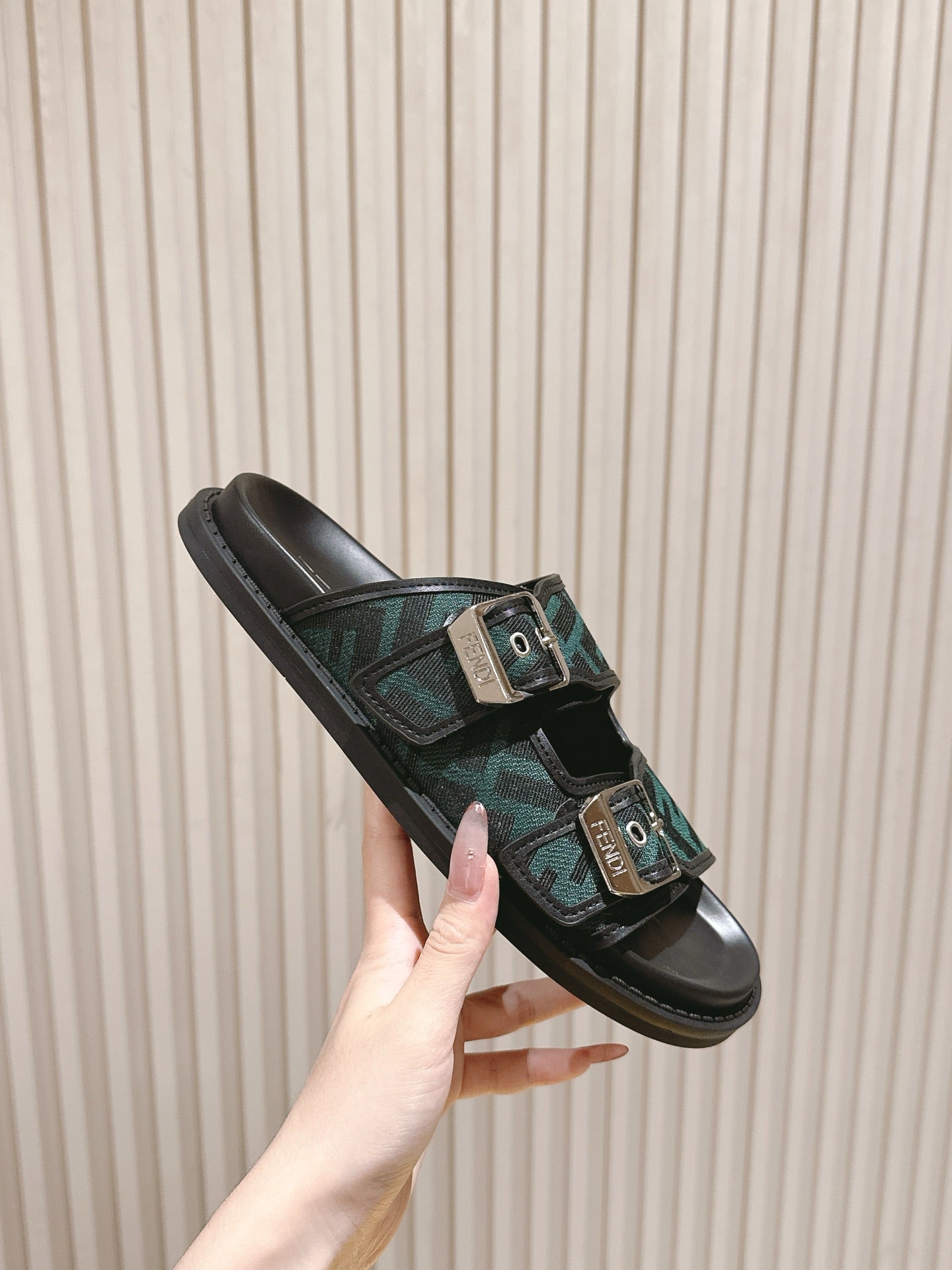 Fendi monogram slide sandals angled view, dark green FF pattern straps with buckles