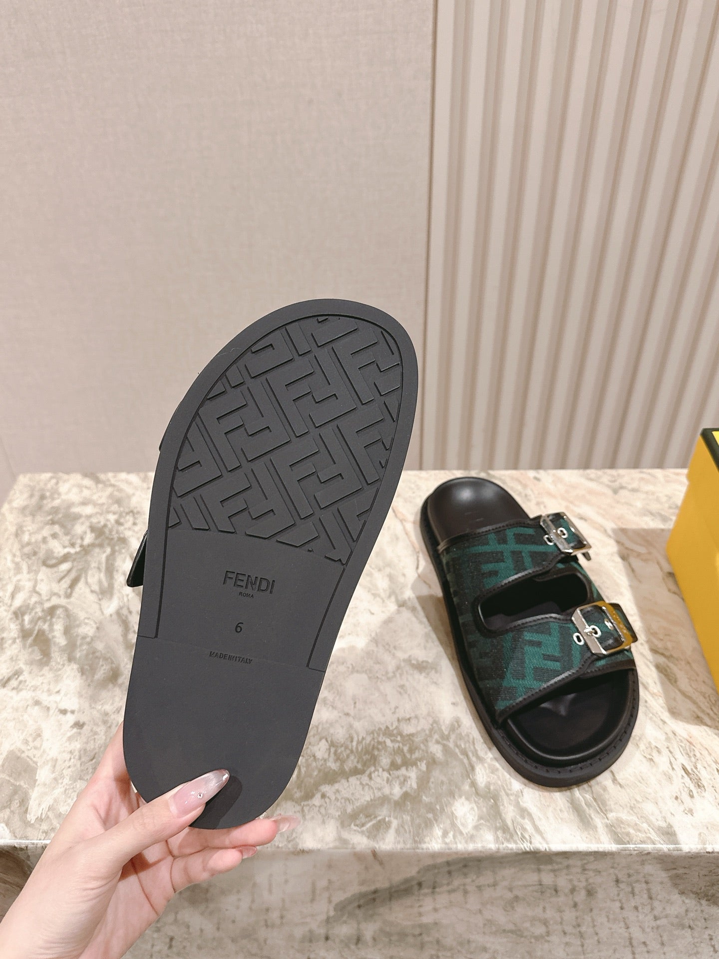 Fendi monogram sandals showing outsole, black tread bottom and side strap
