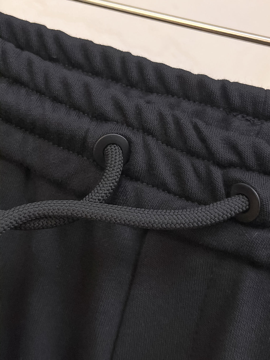 Black elastic waistband with drawstring cords on shorts