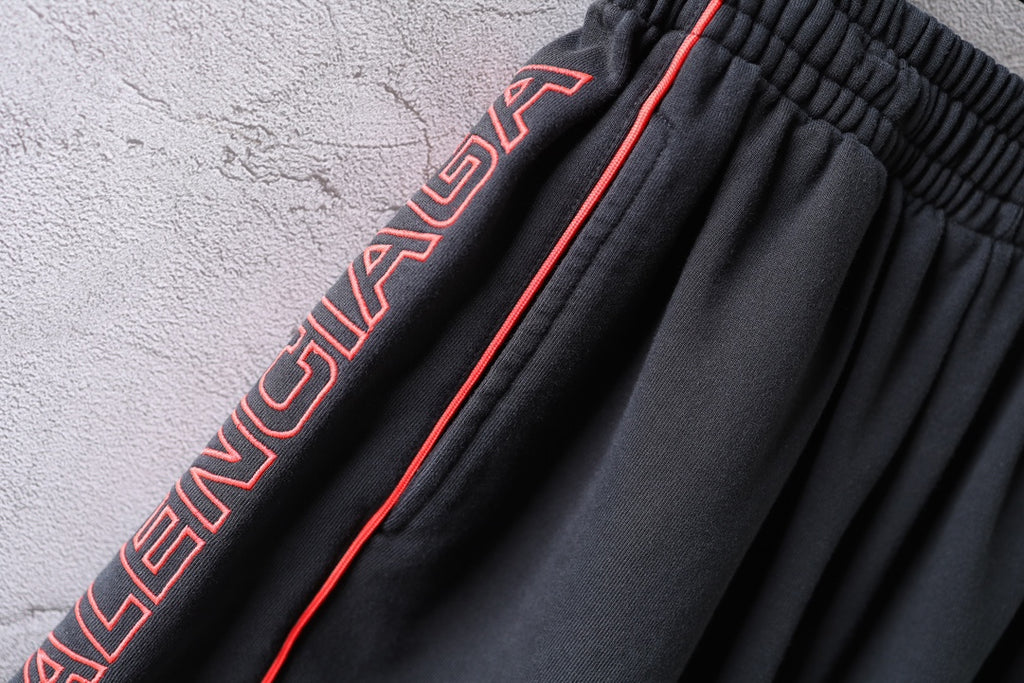 Black Balenciaga shorts side logo embroidery with red piping along the seam.