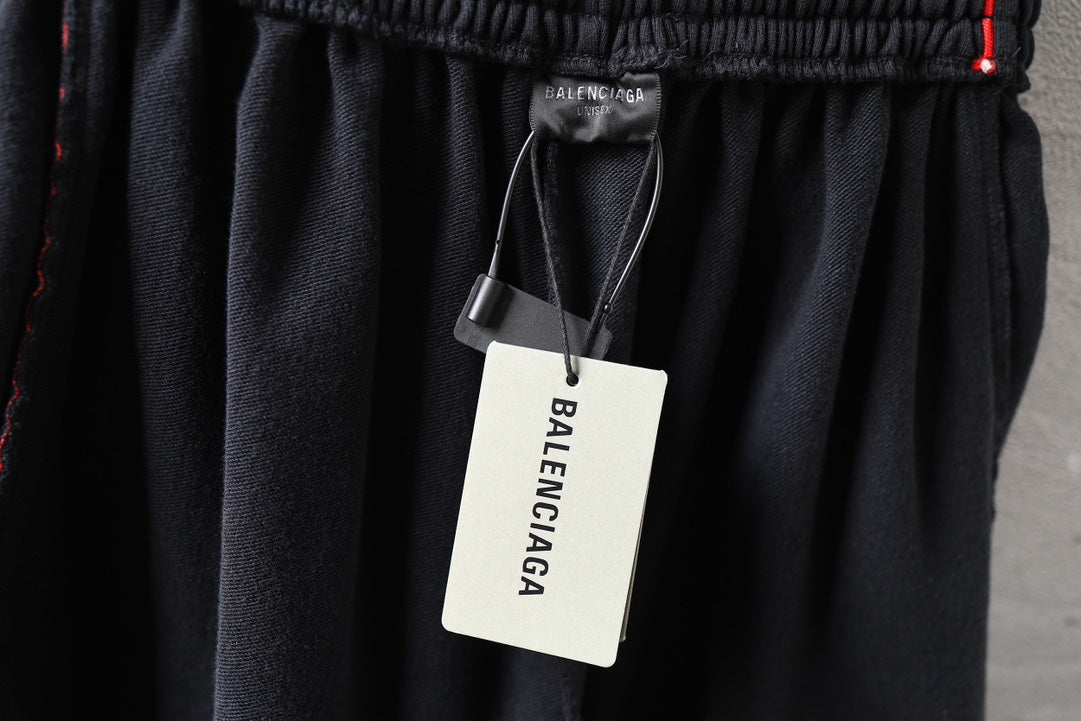 Black Balenciaga shorts with hanging Balenciaga tag at elastic waistband.