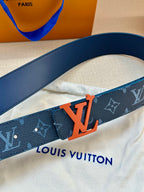 Louis Vuitton belt close-up: dark blue strap, orange LV buckle