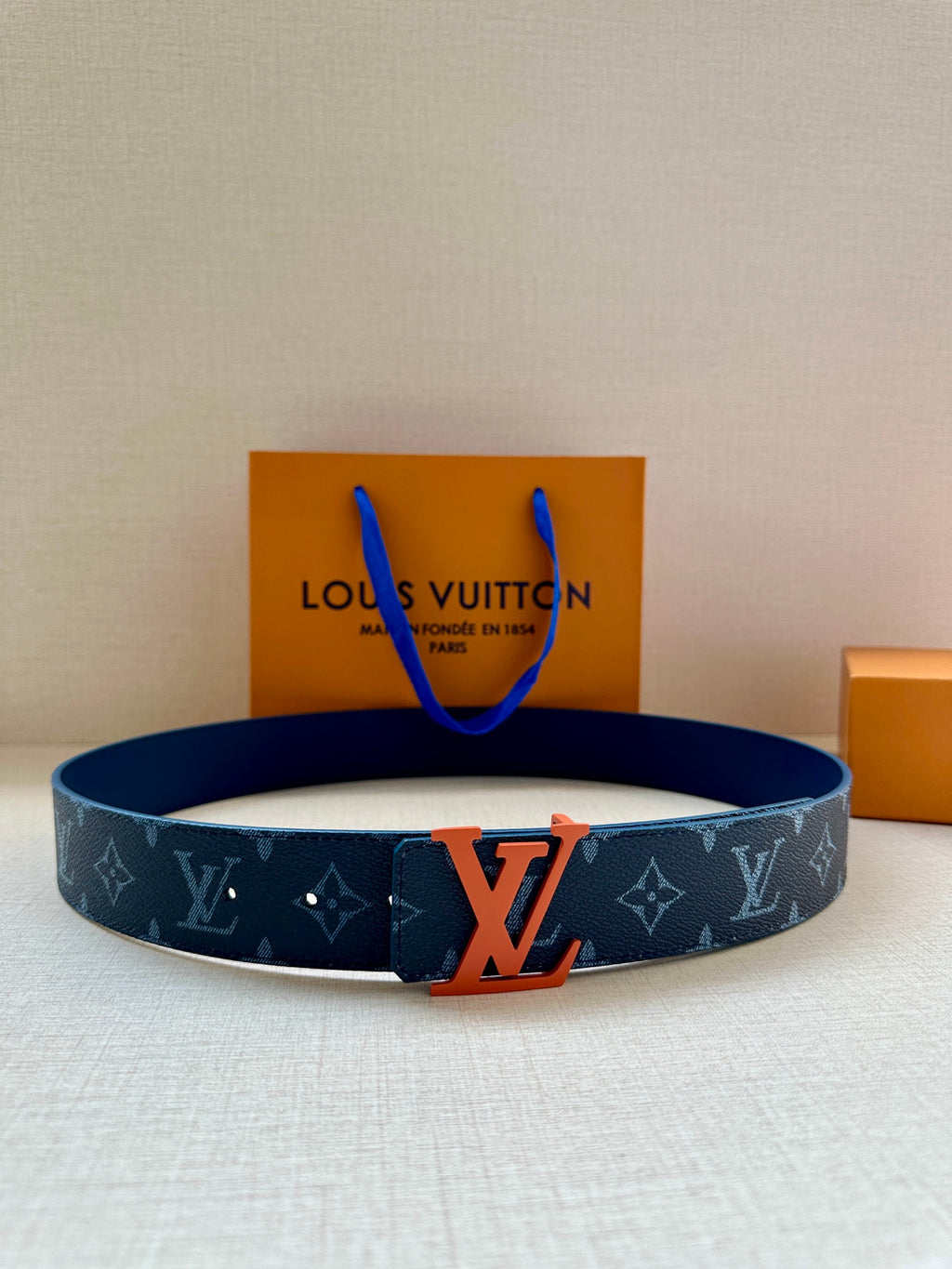 Louis Vuitton monogram belt in dark blue with orange LV buckle