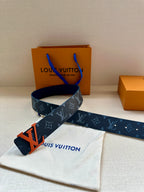 Louis Vuitton belt with dark blue monogram strap and orange LV buckle