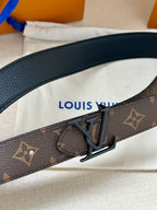 Louis Vuitton monogram belt close-up with dark V metal buckle and leather keeper
