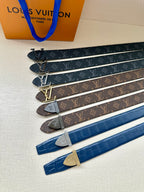 Collection of Louis Vuitton logo belts in multiple colors with gold and silver buckles.