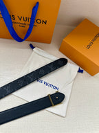 Louis Vuitton monogram belt with gold-tone buckle, dark navy with repeating LV logos.