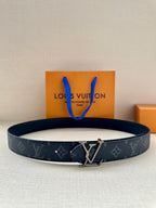 Louis Vuitton monogram belt with silver-tone LV buckle, dark navy repeating logos.