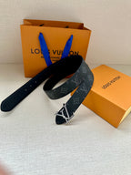 Louis Vuitton monogram belt with silver-tone LV buckle, dark navy leather and logo print.