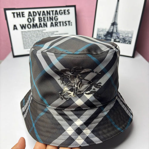 Plaid bucket hat with front crest emblem; black, white, and blue check pattern