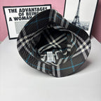 Plaid bucket hat interior view with fabric label and stitched brim; black and blue checks