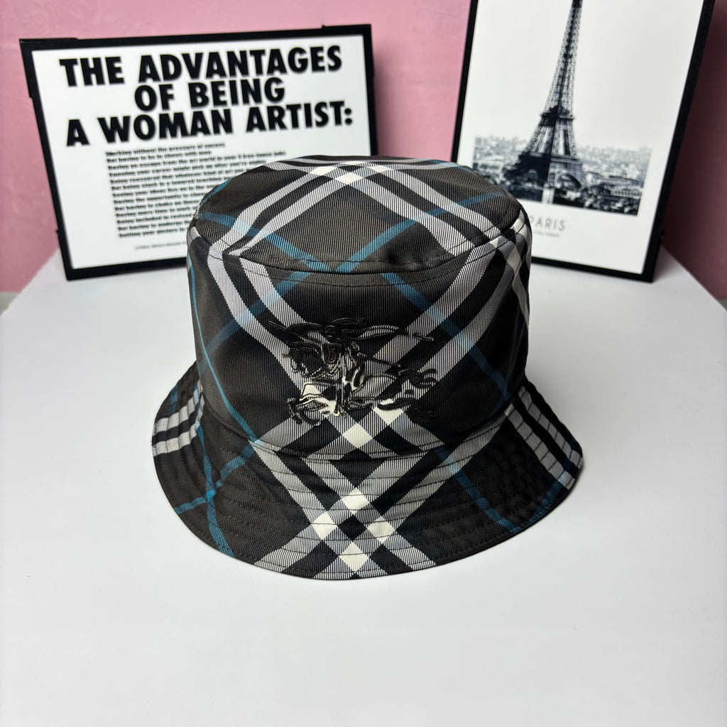 Plaid bucket hat with black, white, and blue stripes and embroidered crest on front