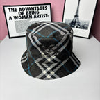 Plaid bucket hat with black, white, and blue stripes and embroidered crest on front
