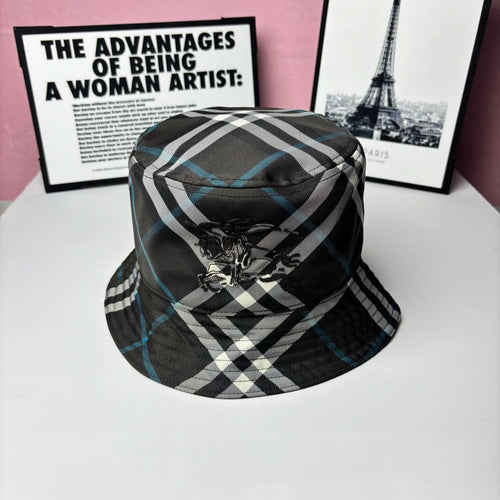 Plaid bucket hat with black, white, and blue stripes and embroidered crest on front