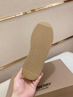 Shoe outsole with tan rubber tread held in hand