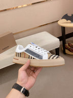 White low-top sneakers with Burberry plaid side bands and cream rubber sole