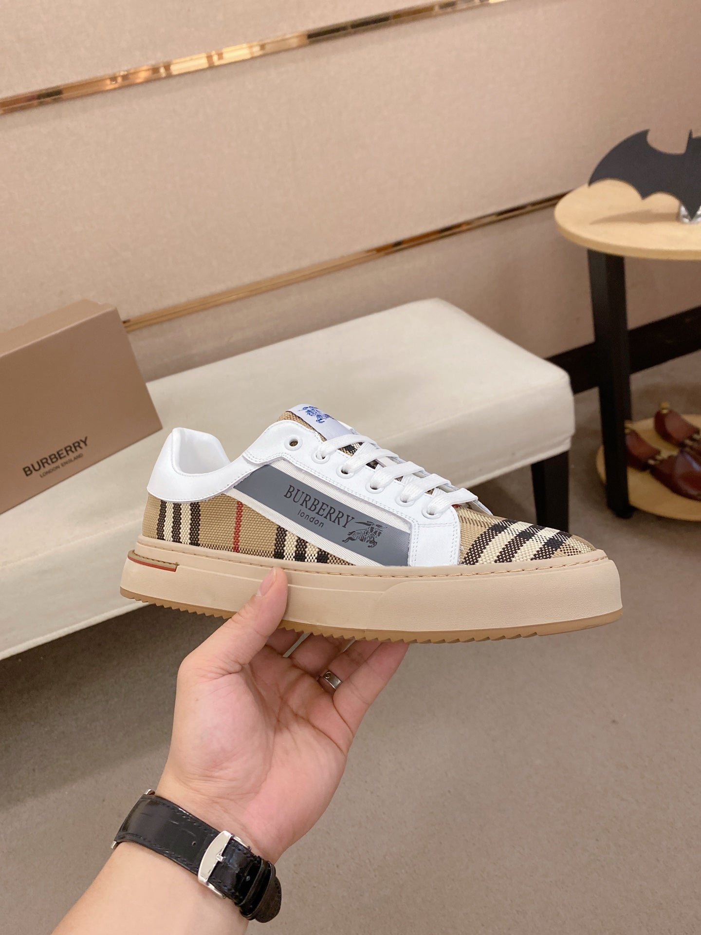 White low-top sneakers with Burberry plaid side bands and cream rubber sole