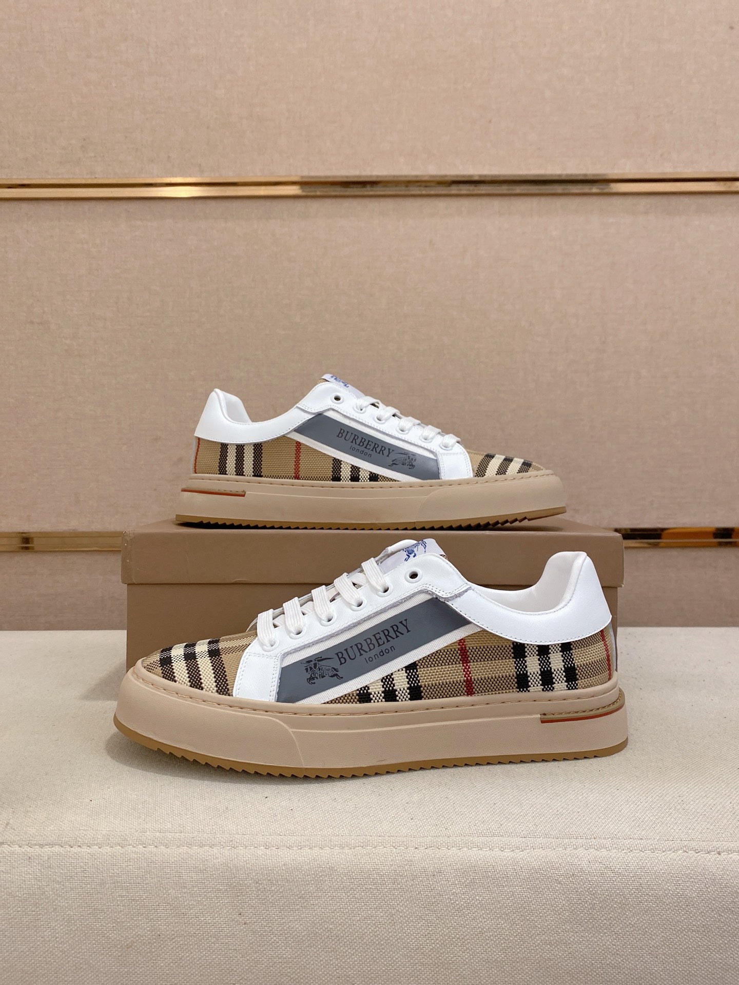 Pair of white low-top sneakers with plaid side panels and cream gum rubber soles