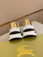 Burberry sneakers back view, white leather with gold heel tabs and black cushioned sole