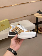 Burberry sneakers in white with tan plaid accents and lace-up front, black sole