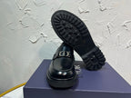 Black leather loafer outsole with ridged tread and square buckle strap