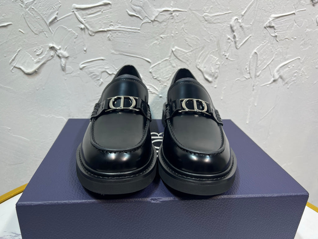 Black leather unisex loafers with square buckle detail and thick platform sole