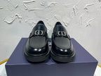 Black leather unisex loafers with square buckle detail and thick platform sole