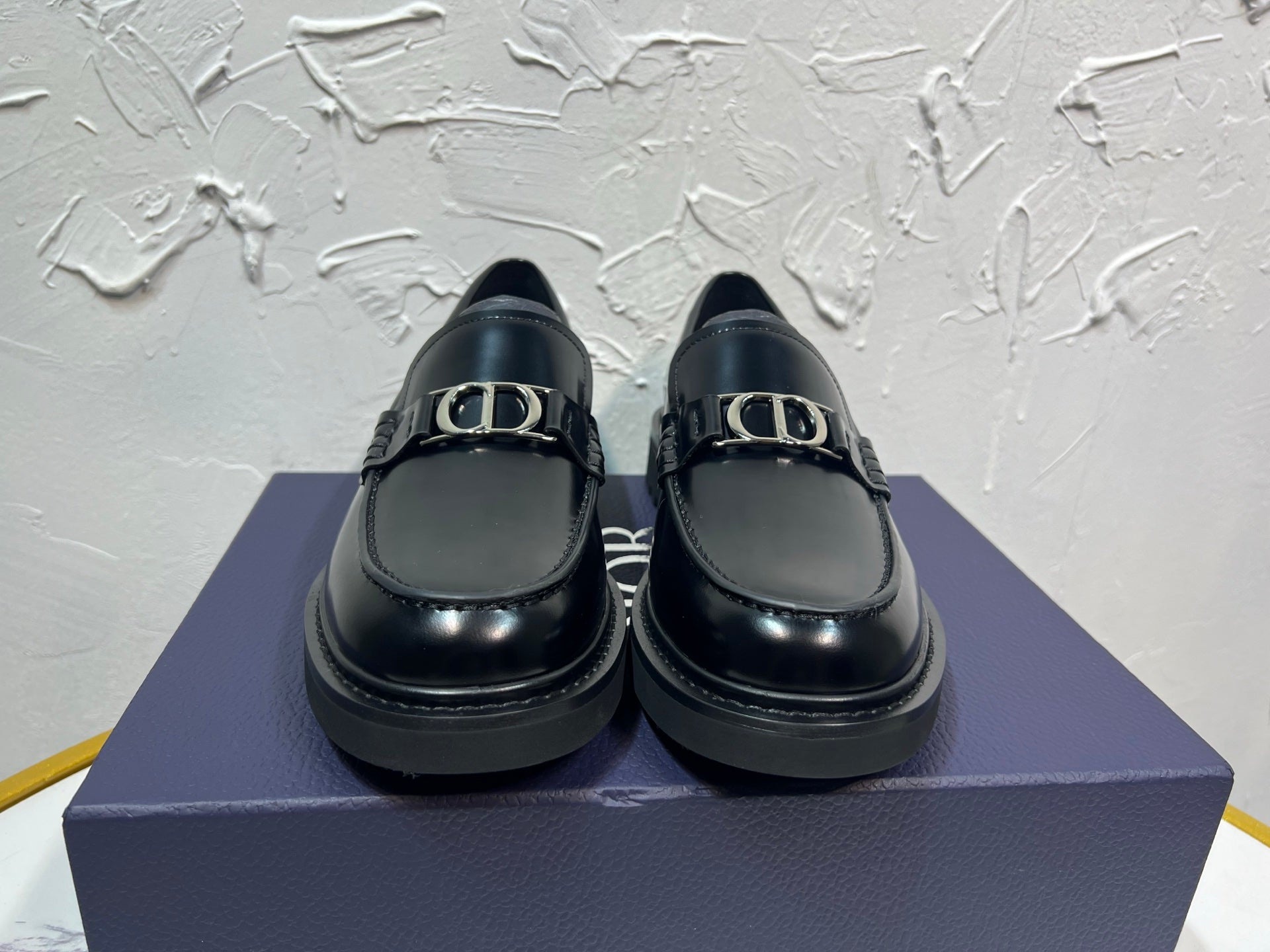 Black leather unisex loafers with square buckle detail and thick platform sole