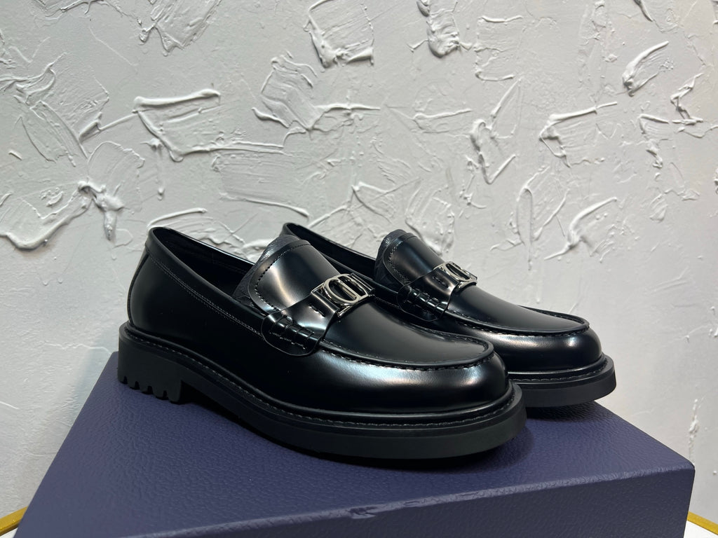 Black leather loafer with square metal buckle and stitched moc toe, platform sole