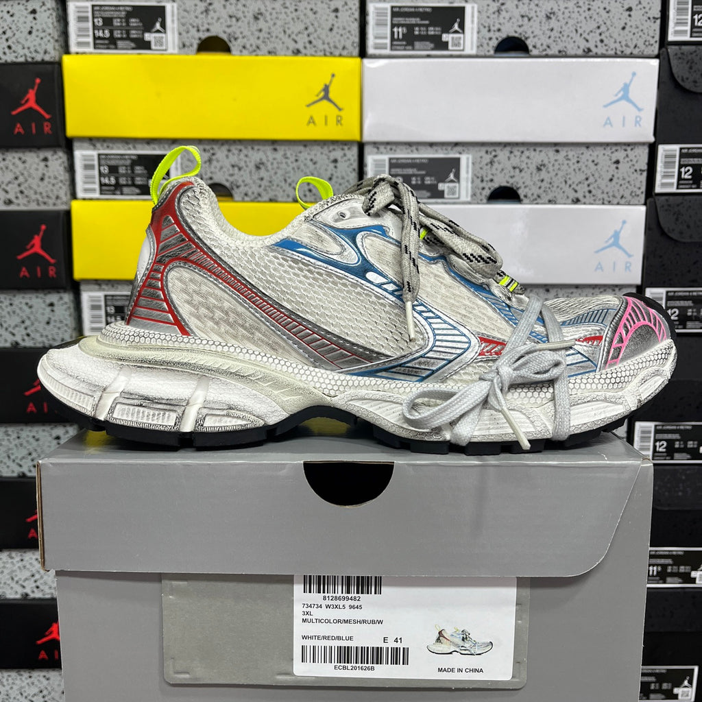 Chunky lace-up running shoe in white mesh with blue accents, pink heel trim, green laces.