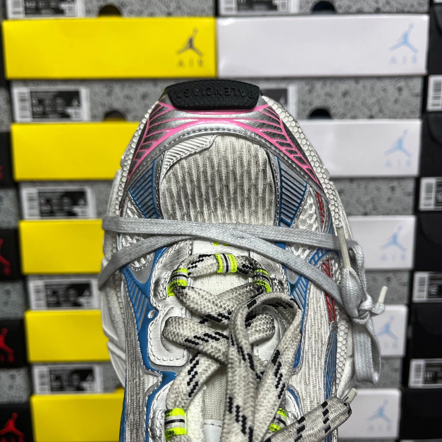Shoe heel and collar: white mesh lining with blue accents and pink trim, neon green laces.