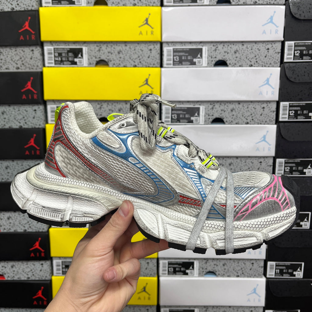Lace-up running shoe with white mesh, blue panels, pink heel detail, neon green laces.