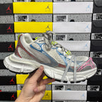 Lace-up running shoe with white mesh, blue panels, pink heel detail, neon green laces.