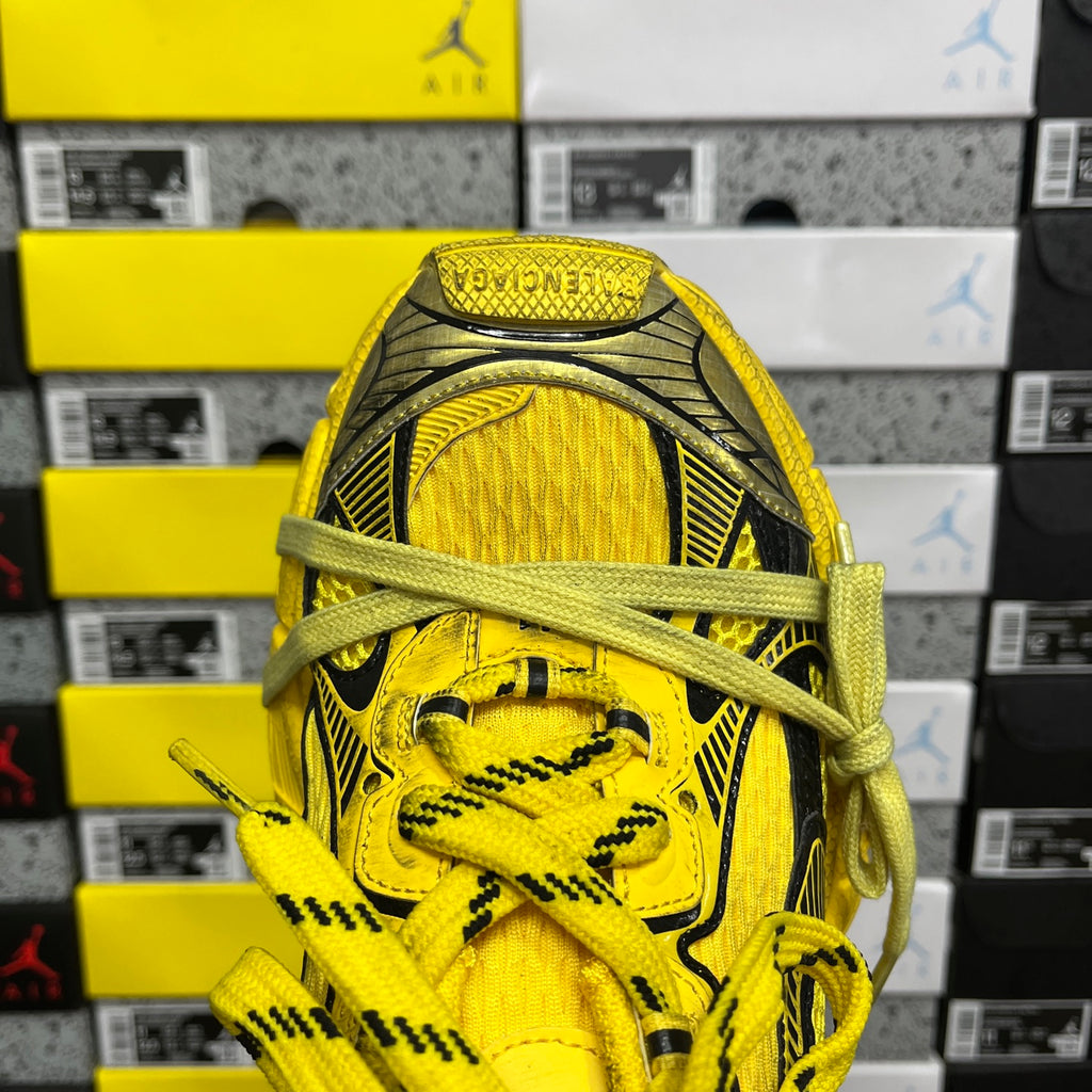 Yellow lace-up sneaker toe with black trim and textured knit panels