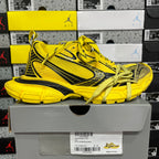 Yellow lace-up sneakers with black accents and textured rubber sole