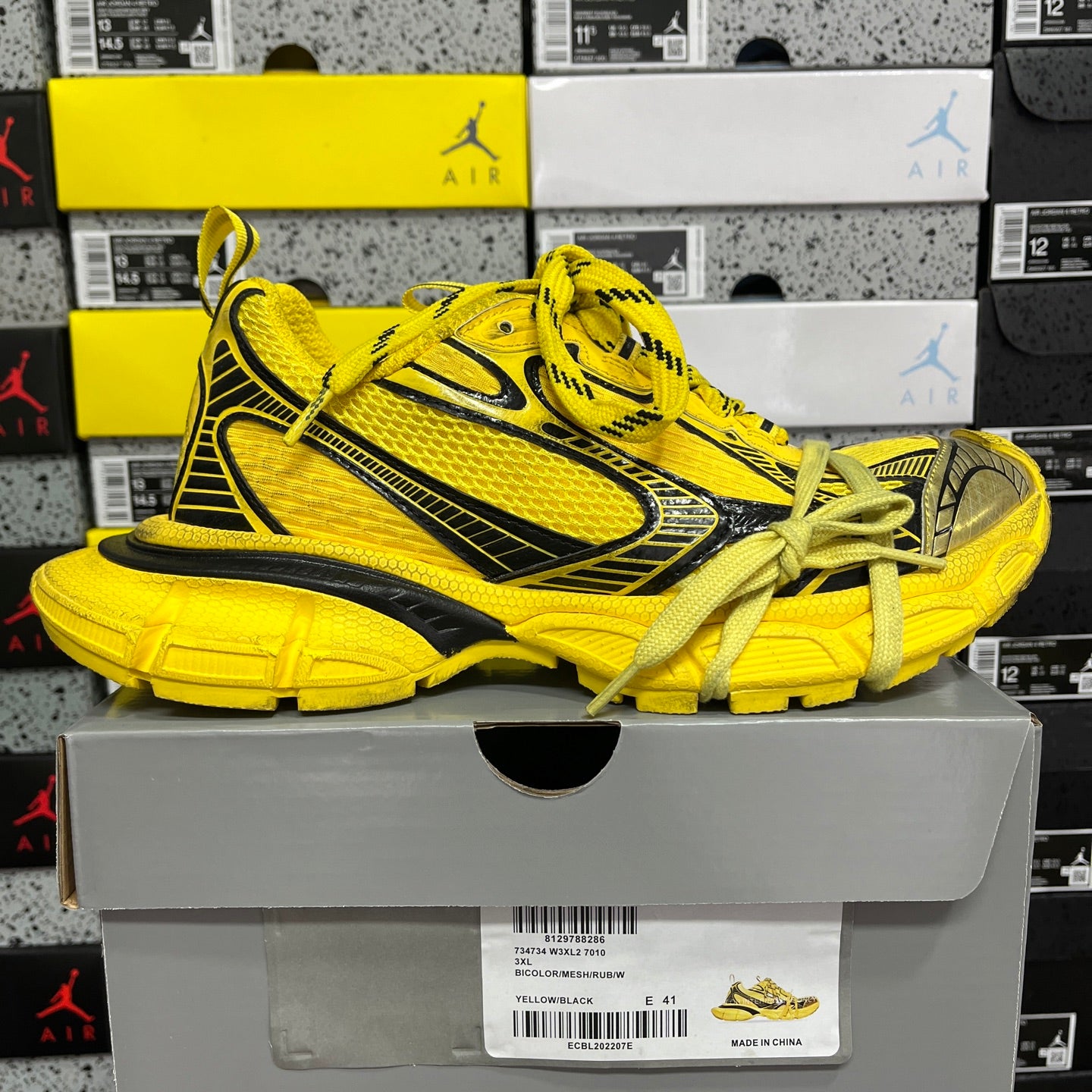 Yellow lace-up sneakers with black accents and textured rubber sole