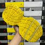 Yellow rubber outsole with grid traction pattern and side wall stripe