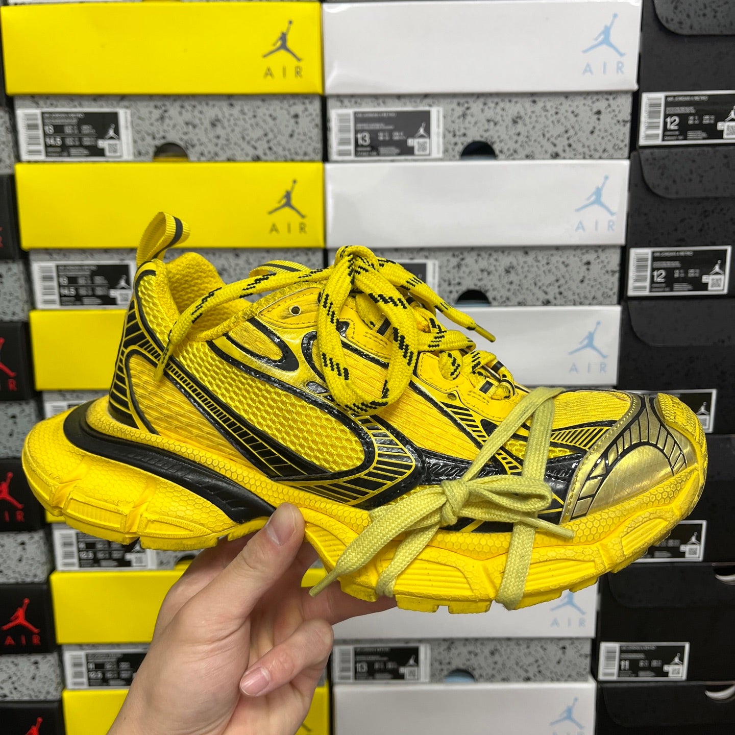 Yellow lace-up sneakers with black side stripes and chunky rubber sole